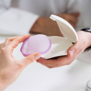 Gynecologist Consulting Woman On Diaphragm Contraception And Birth Control Method