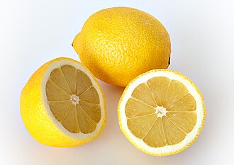two lemon halves and a full lemon on a white background