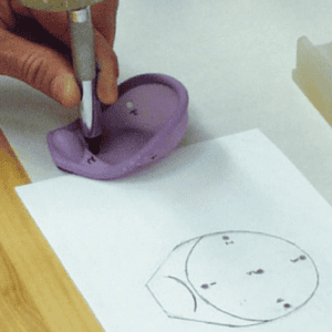 Diagram and hand holding pen measuring aspects of the female Caya diaphragm.